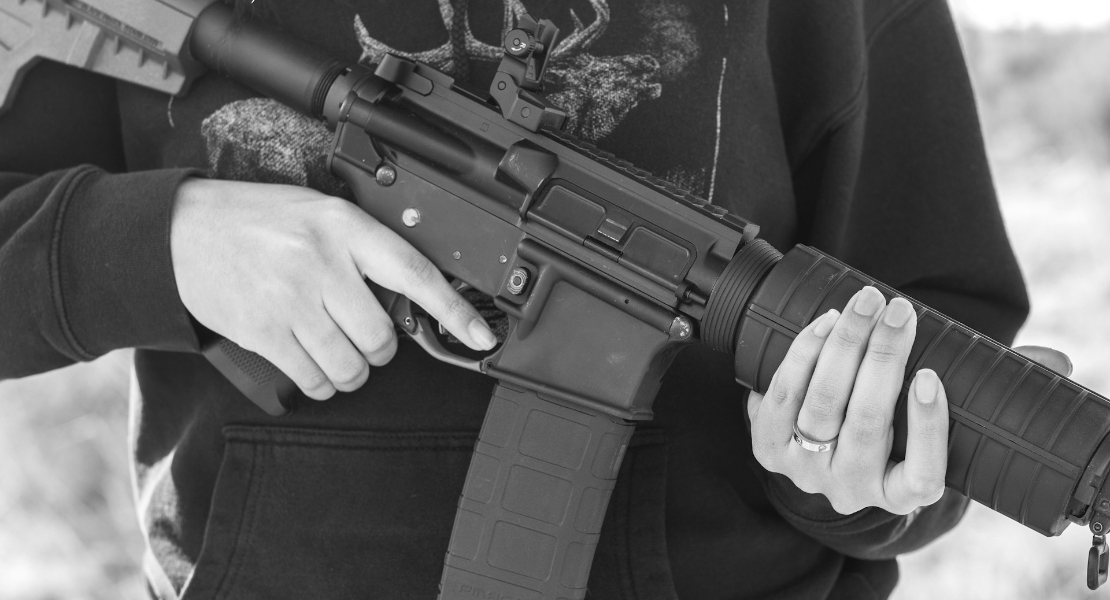 Person holding an AR-15 rifle