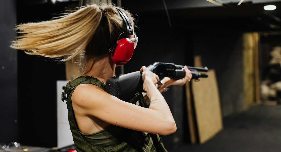 A woman shooting in a range session.