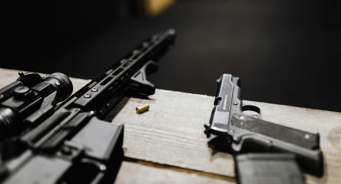 Guns laid on a desk.