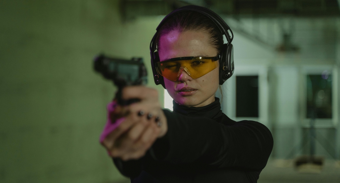 a girl shooting with a gun thinking about AK-47 vs AK-74 differances