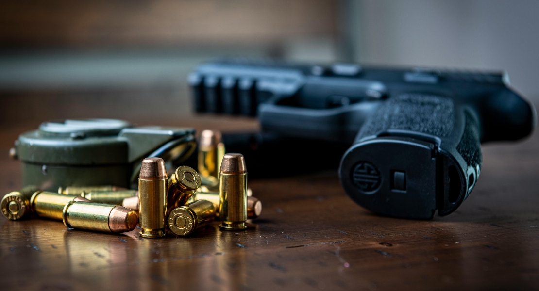 bullets and a gun with barrel length