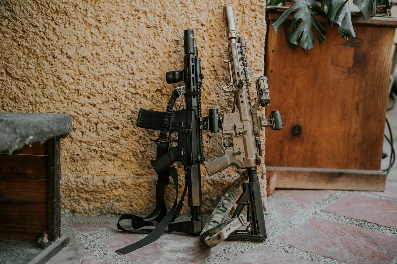 two types of AKs against a wall