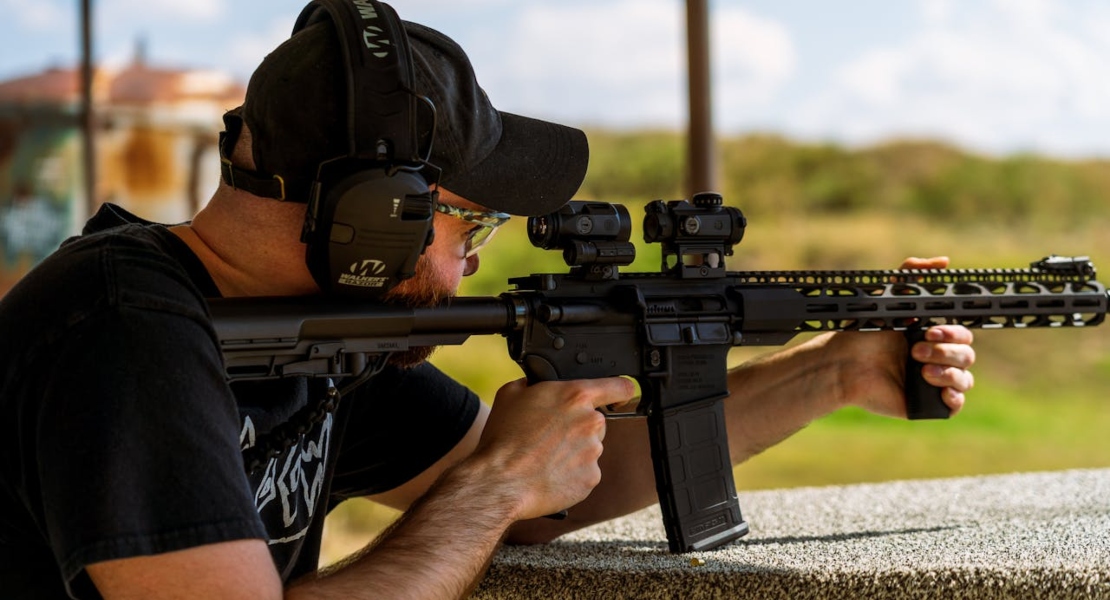 a man holding a gun and thinking about common firearm myths