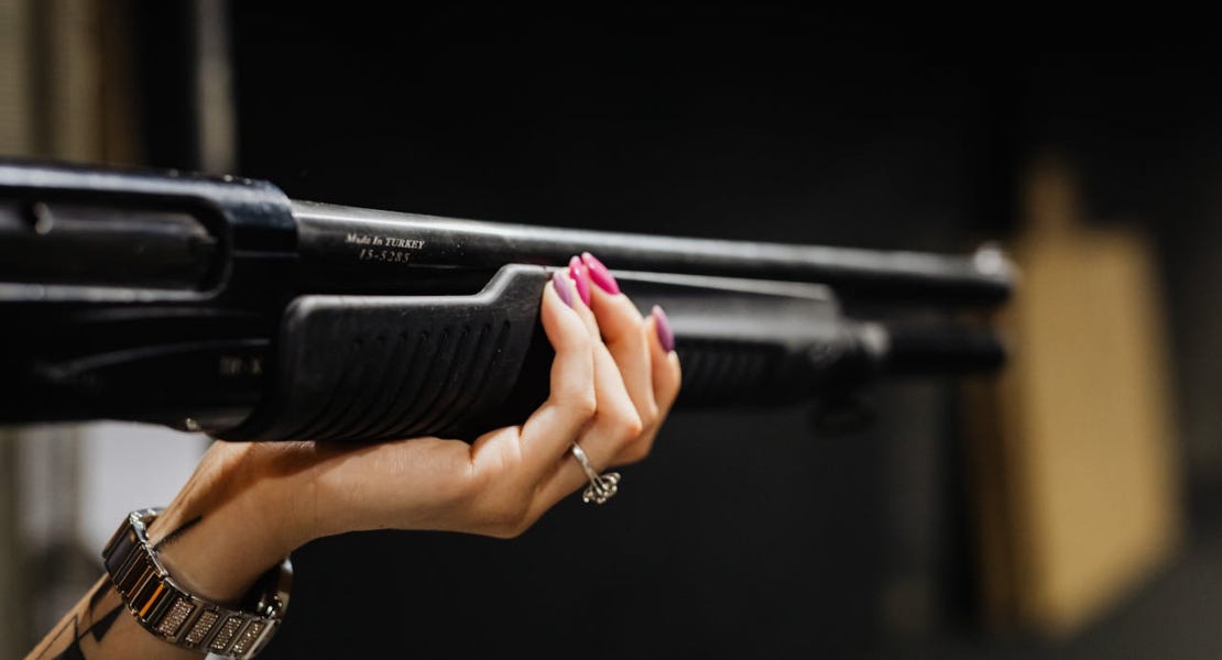 a woman holding a rifle