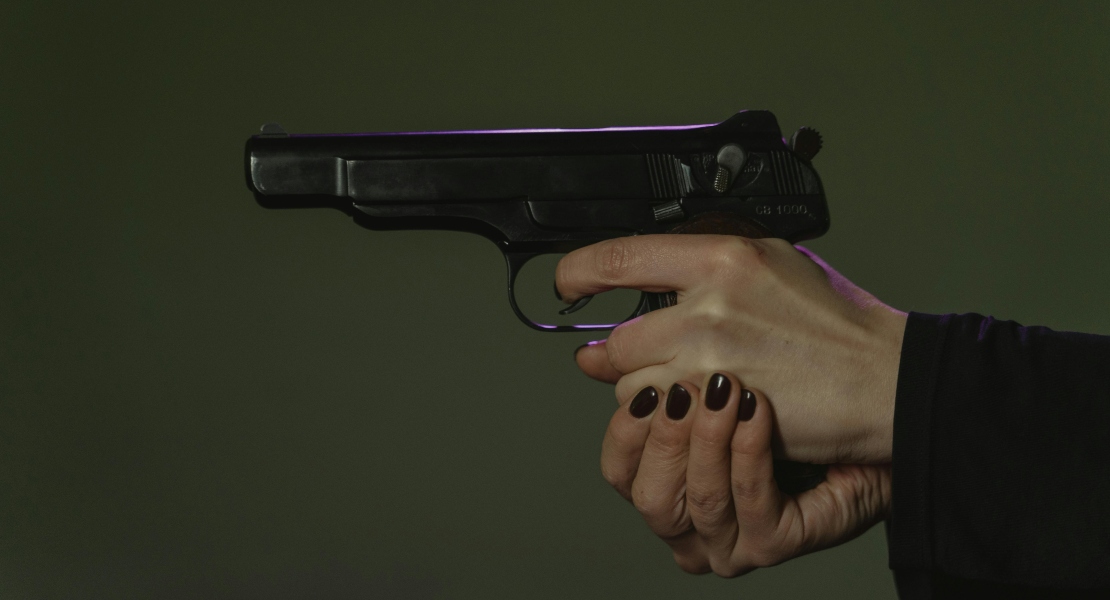 Close-up of a handgun during firing.