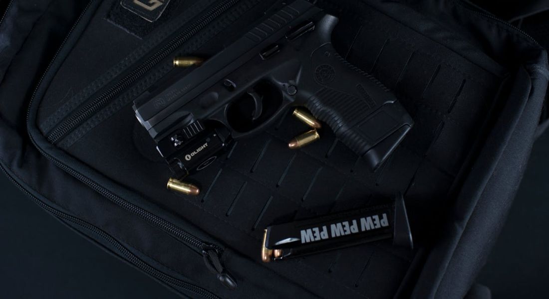a gun in a case with bullets scattered around it