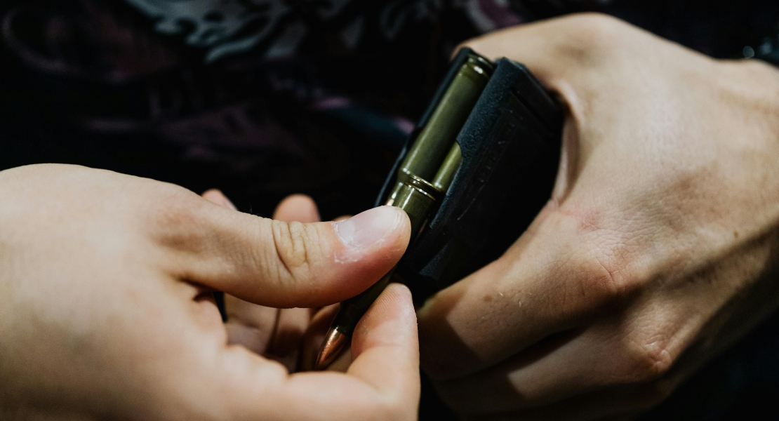 A man loading an AK magazine.
