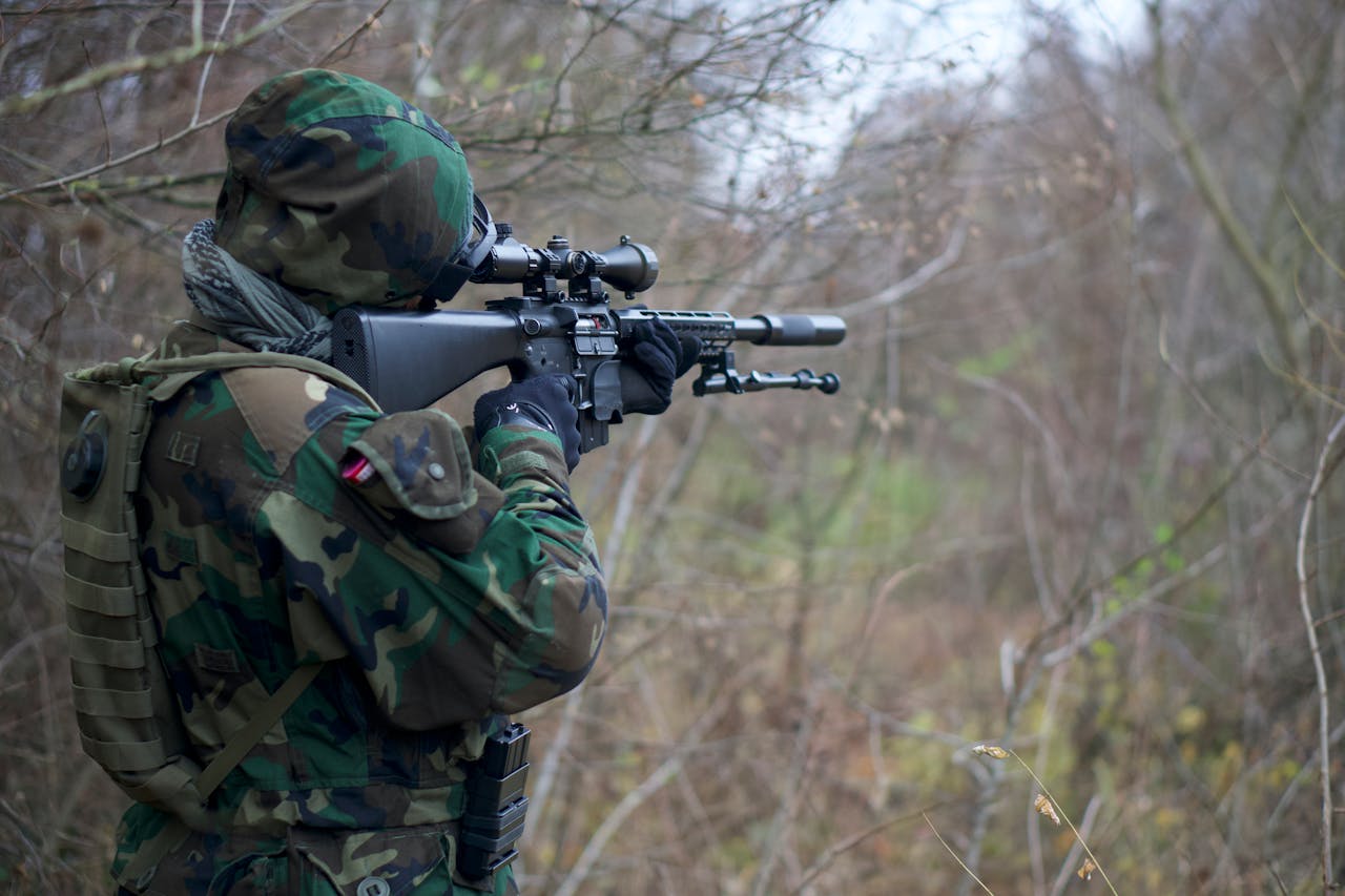 a solider holding one of the military firearms that failed in the civilian market