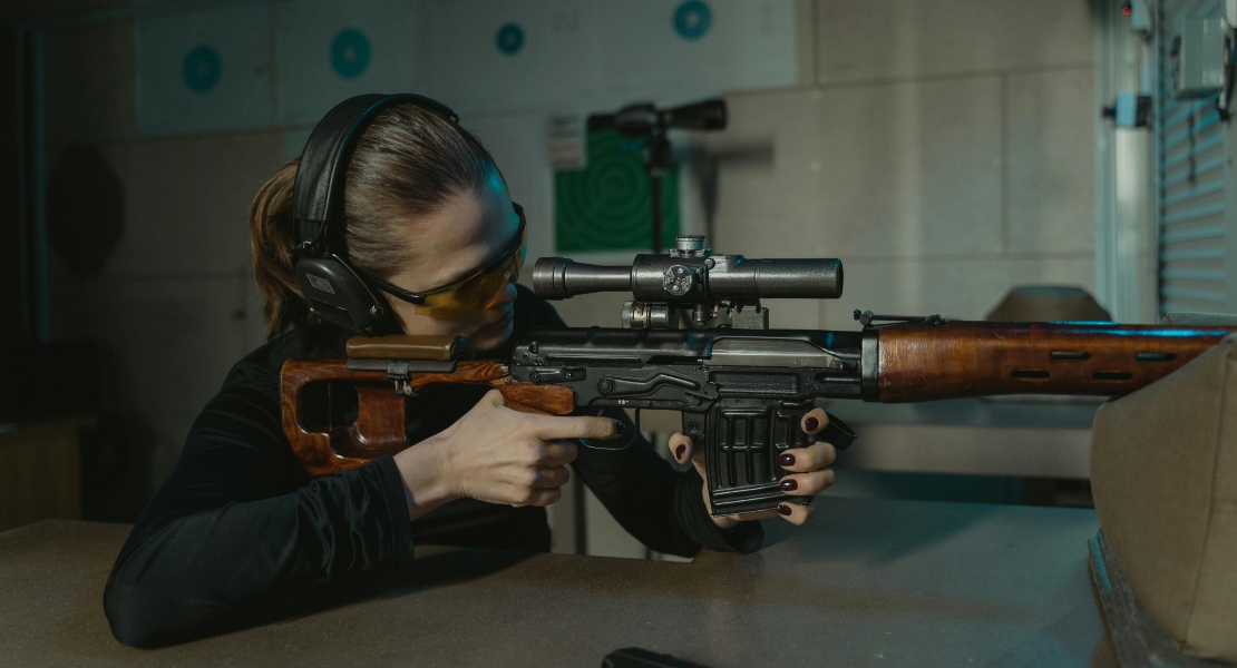 A person shooting from a rifle.