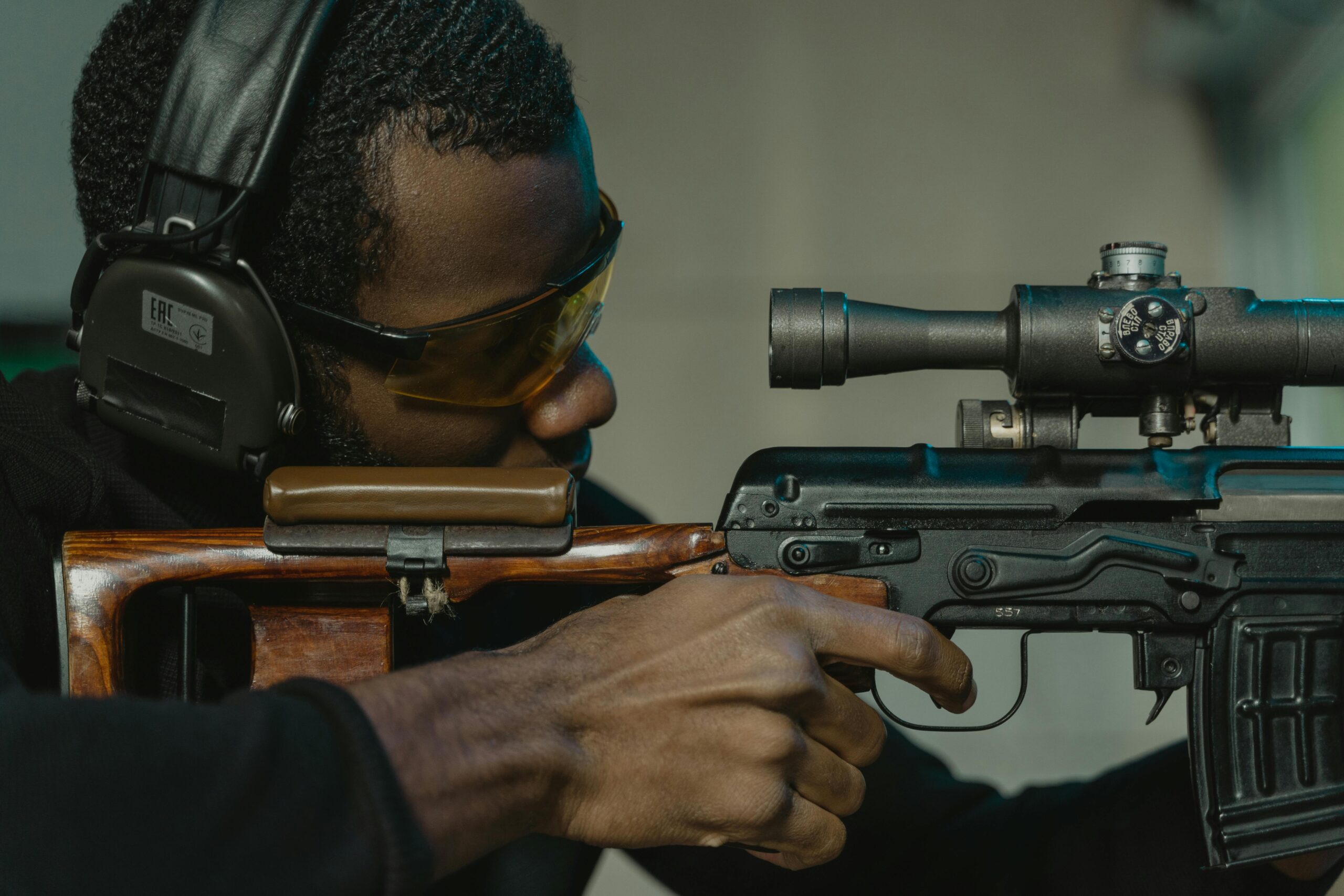 A person shooting from a rifle.