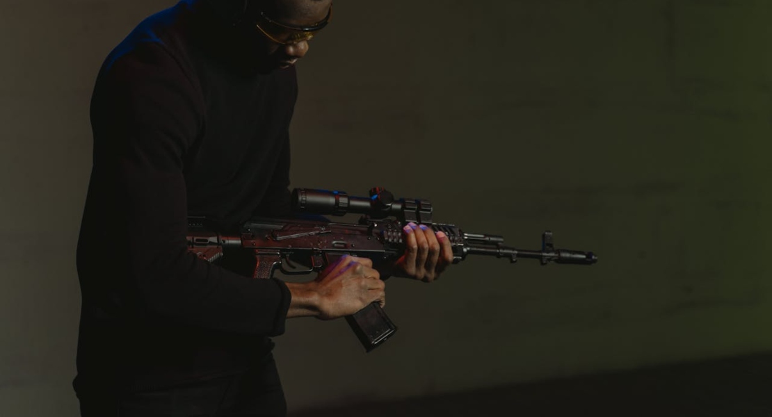 a man holding a weapon and thinking about stamped vs milled AK receivers