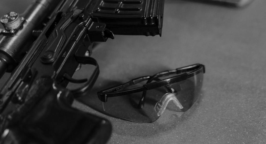 safety glasses next to a gun