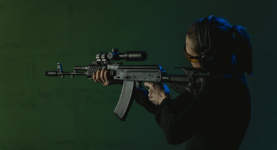 a woman shooting from a rifle