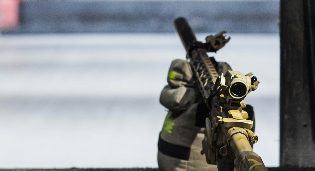 a rifle with small firearm components inside propped up by a bag