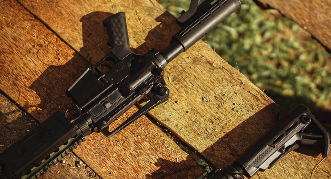 a gun on a wooden desk outside