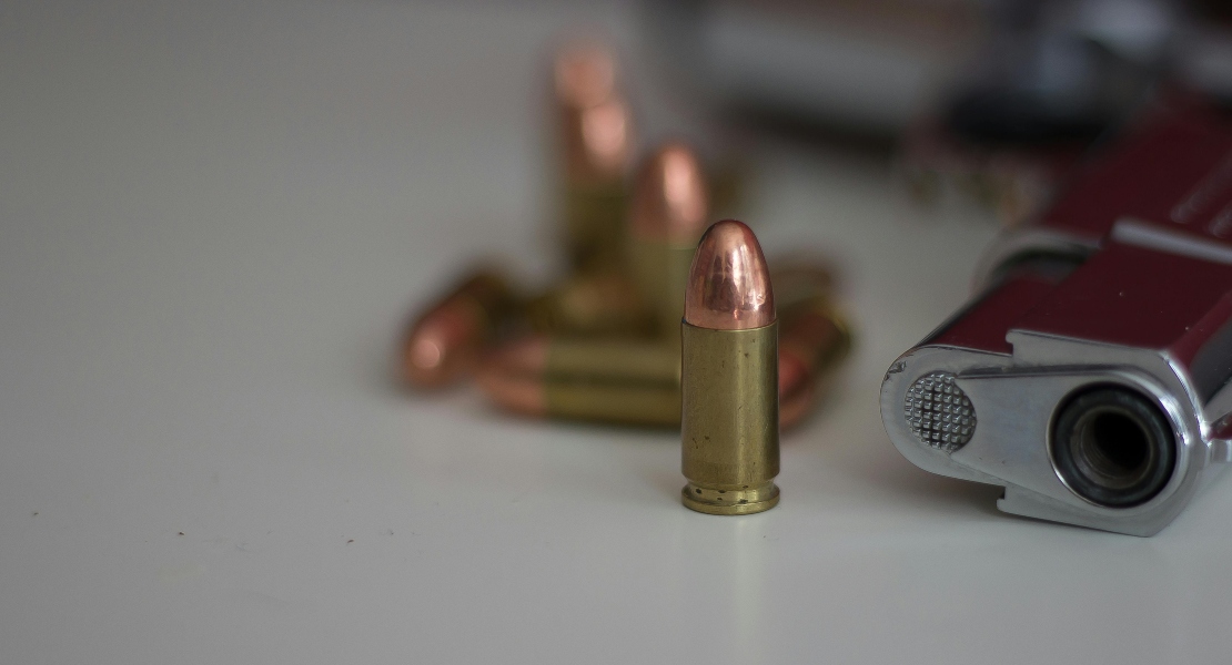 Firearm with ammunition displayed, representing inspection process to detect early trigger component issues.