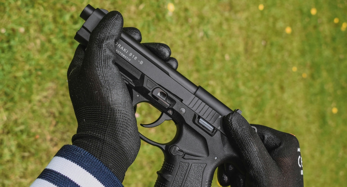 Close-up firearm inspection showing trigger mechanism being checked for inconsistent pull resistance and internal wear.