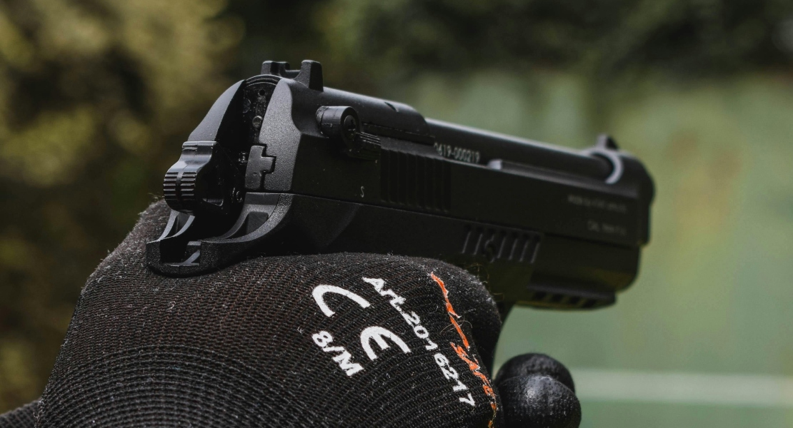 Person holding a firearm during shooting stance.