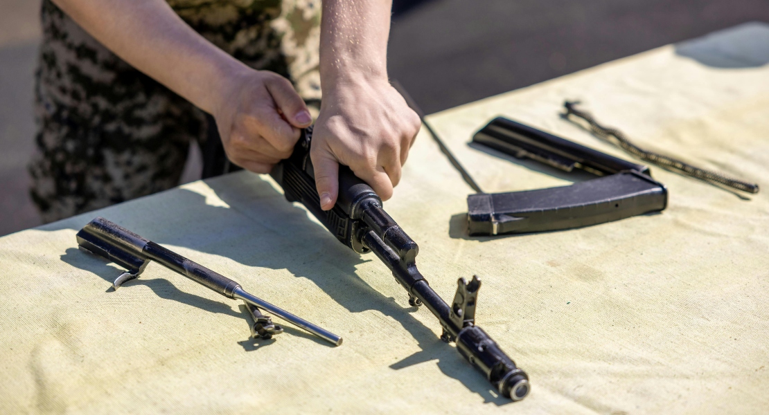 A man showing firearm parts buying mistakes on a rifle.