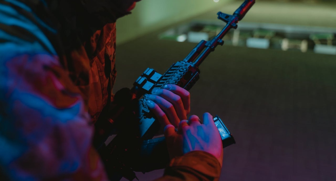man holding firearm while inspecting part condition and wear