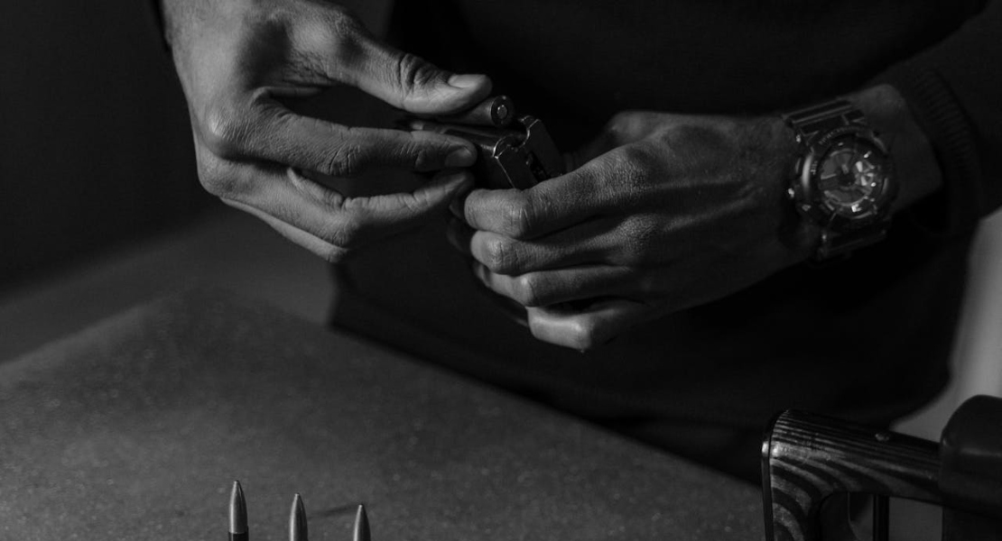 a man holding a gun and trying to figure out what is a detent in firearms
