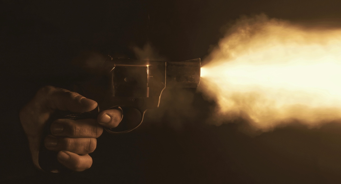 A close-up of a gun firing a bullet.