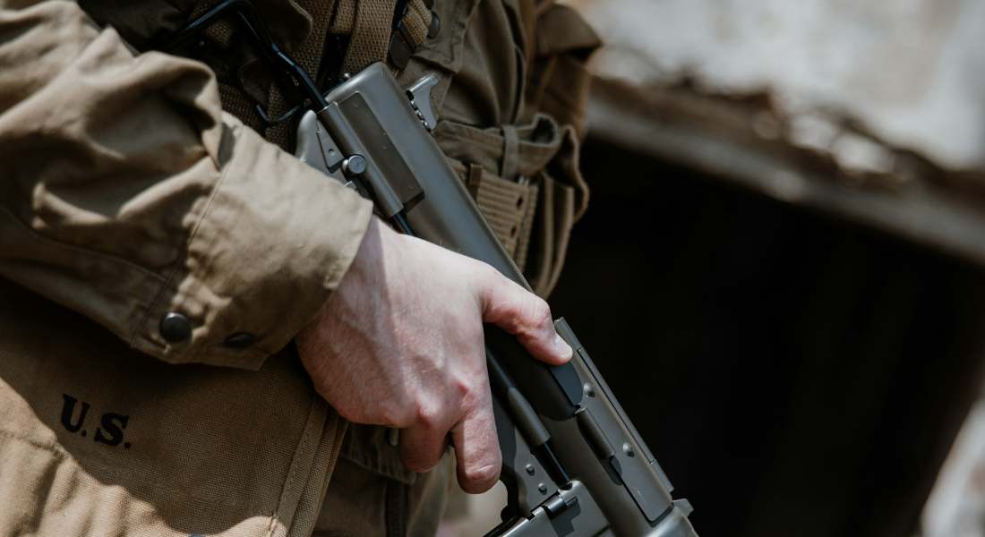a close-up of a soldier holding machine gun