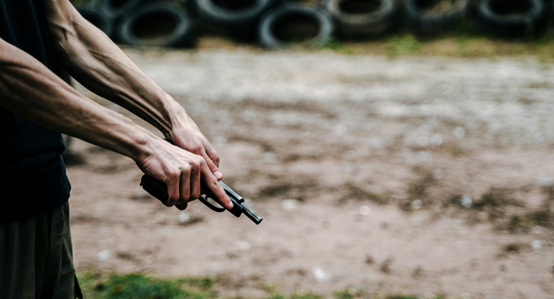A man holding a gun with super safety cam and lever.
