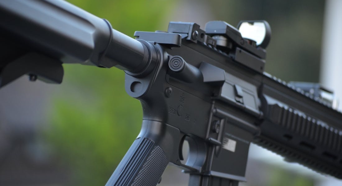 Close-up of a black airsoft rifle with detailed firearm-style components