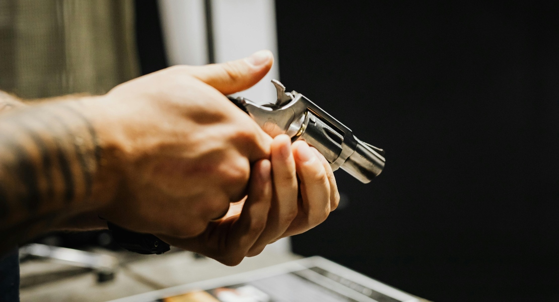 shooter inspecting a disassembled firearm checking internal components for wear