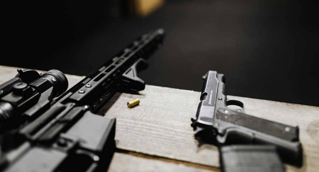 Guns on a desk.
