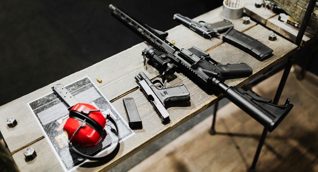Guns on a desk.