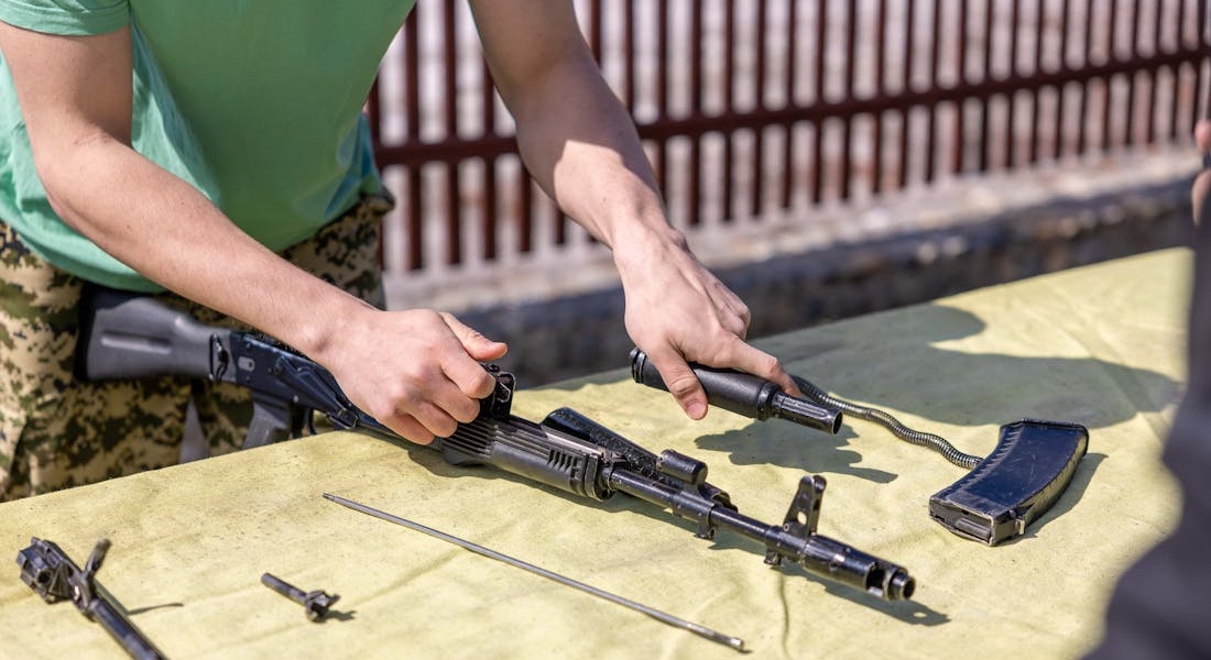 Man assembling a rifle after learning how to clean and maintain a super safety system