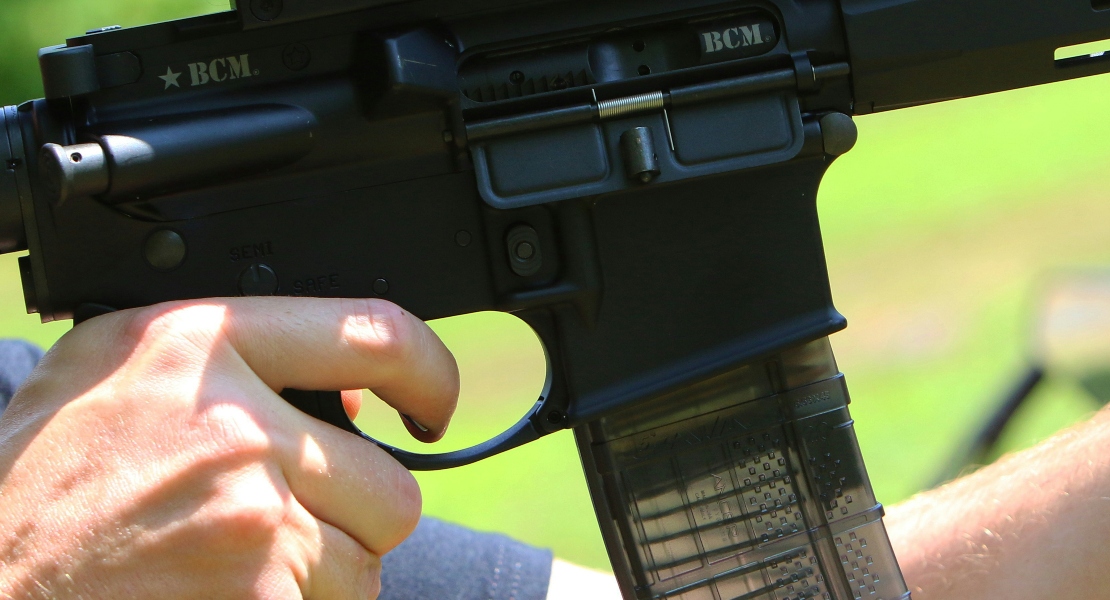 A man holding a rifle with a super safety trigger.