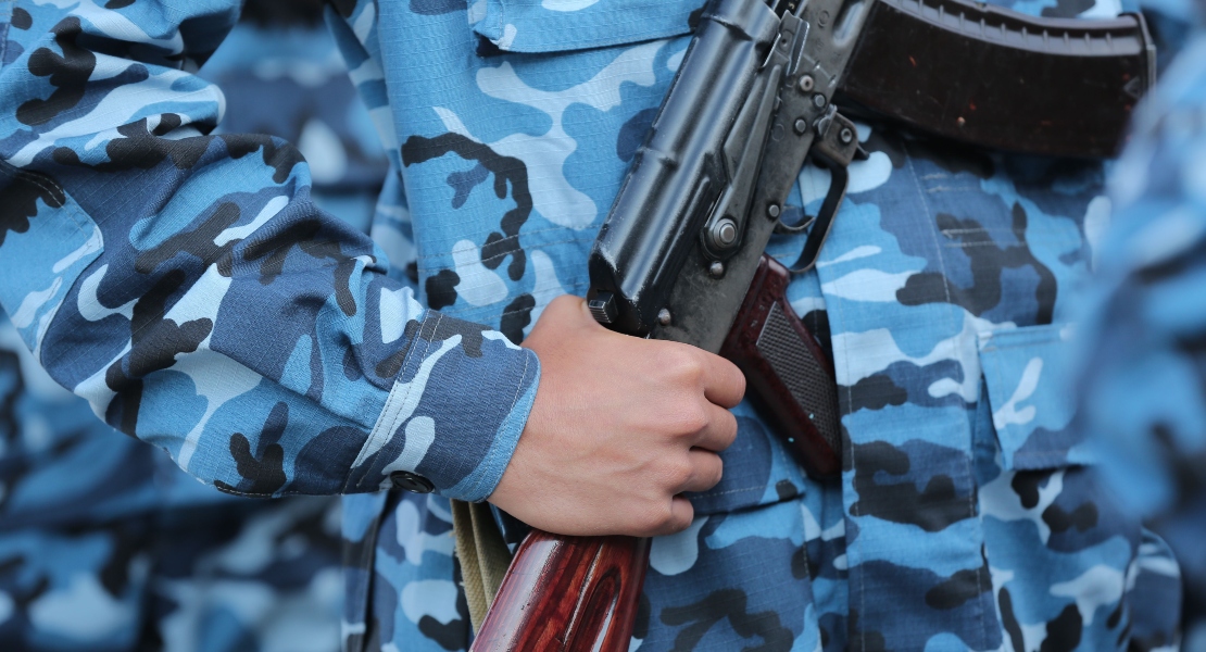 A soldier holding a rifle with AK super safety installation problems.