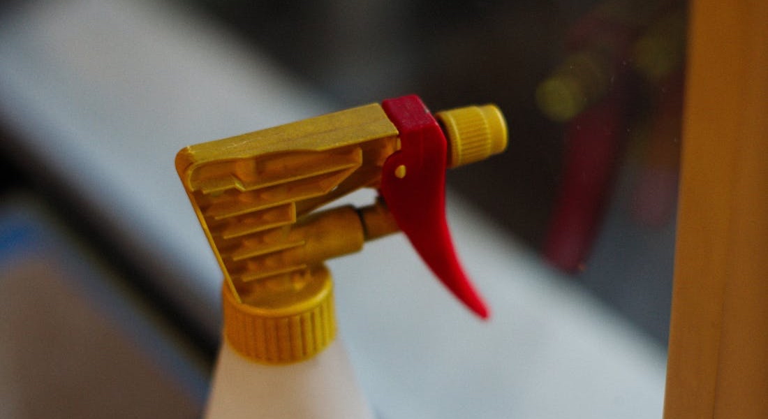 Red and yellow lubricant spray bottle