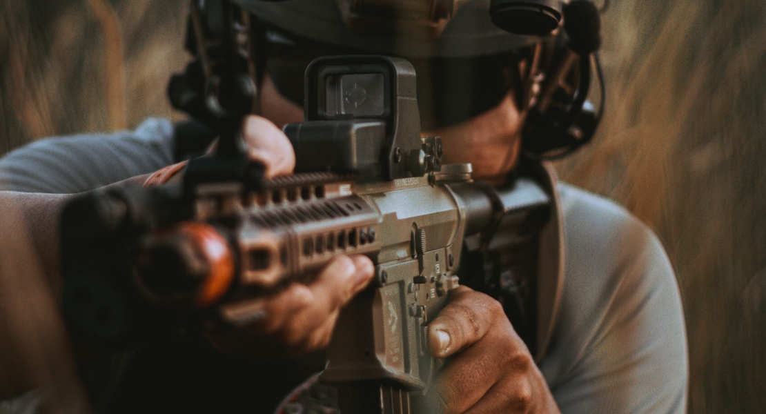 A man aiming with a rifle.