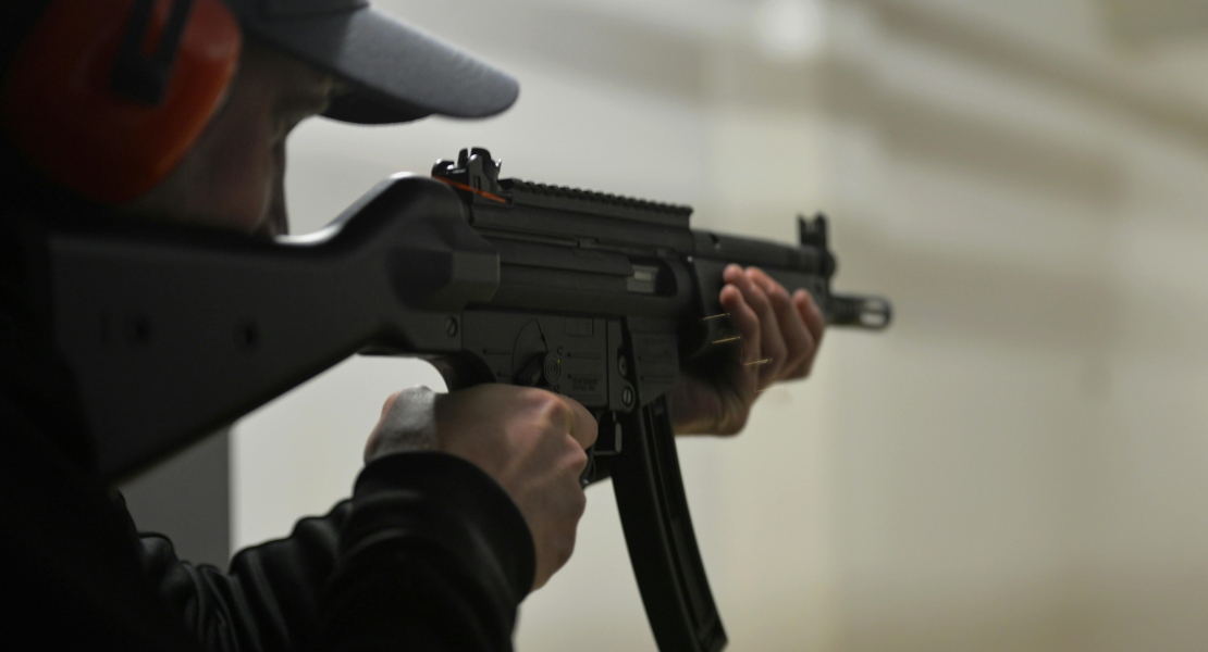 A man holding a gun with mp5 lower super safety build.