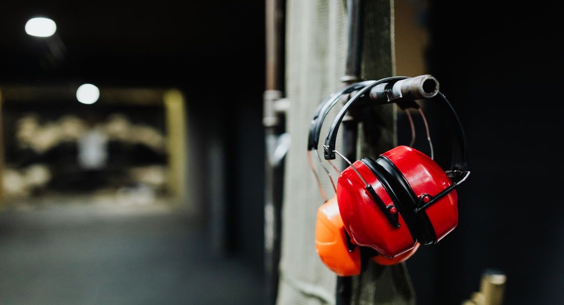 Hearing protection hanging at an indoor shooting range