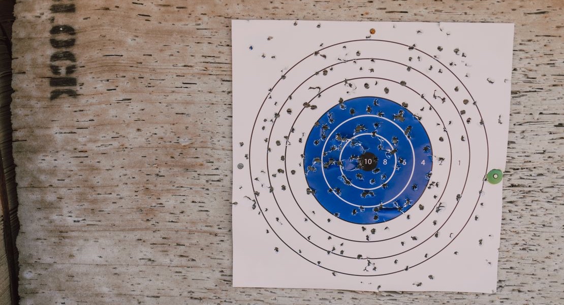 Paper shooting target with multiple bullet impacts after a practice session