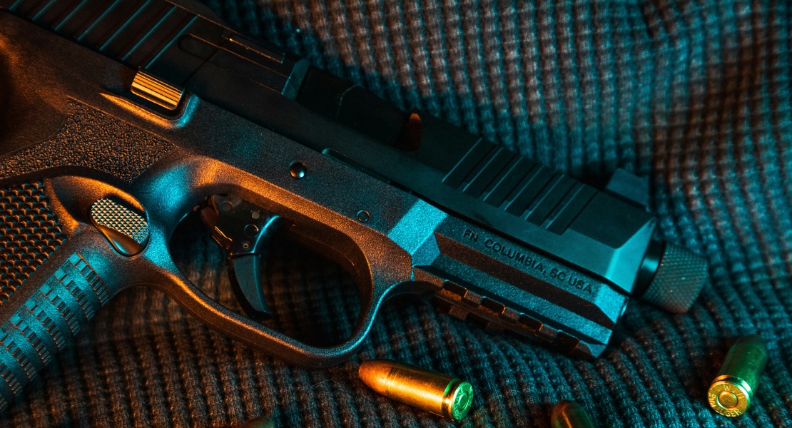 A gun with bullets around it.