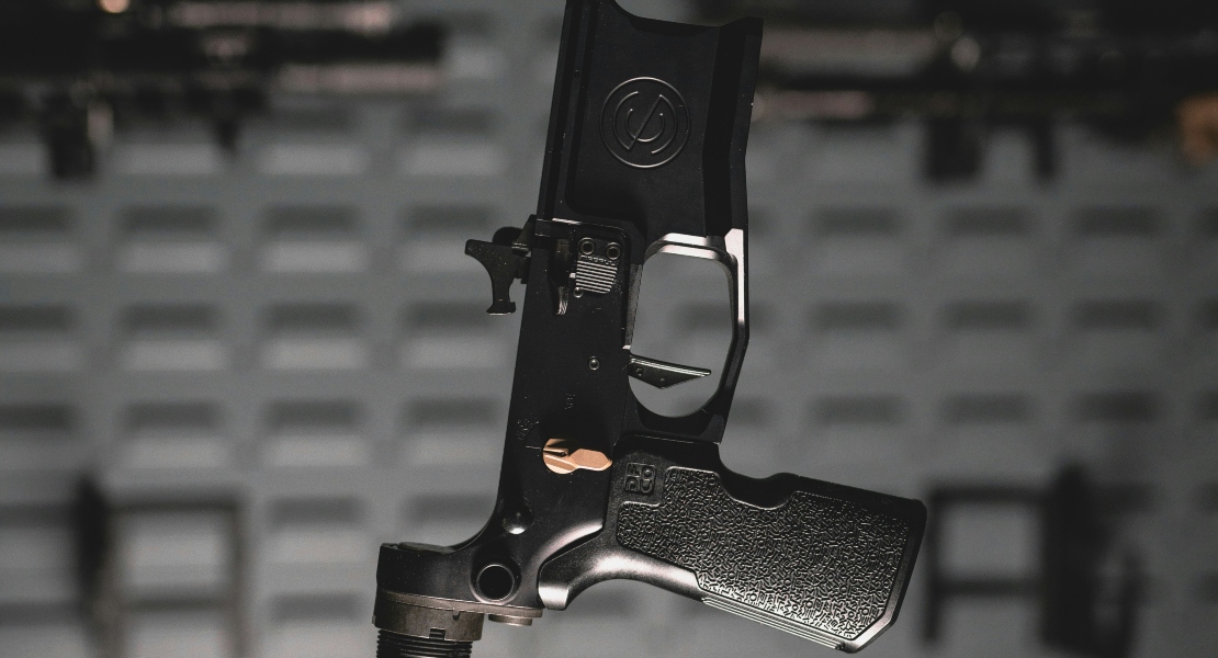Close-up of an AR-15 lower receiver, showing the super safety vs forced reset trigger difference in practice.