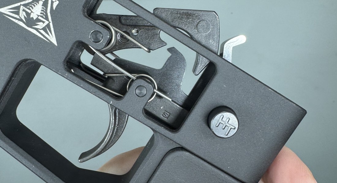 a close-up of AR-15 fire control group components during dead trigger super safety diagnosis