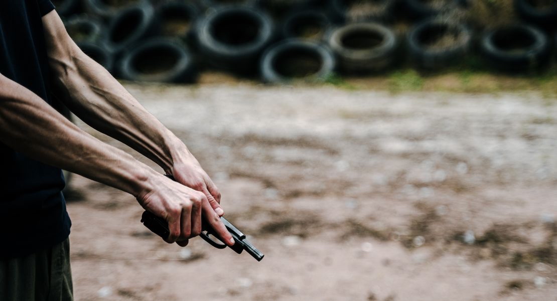 A person holding a pistol