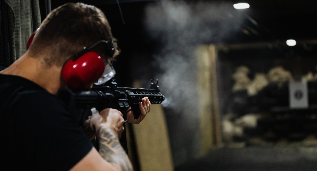 A man shooting from an M16.