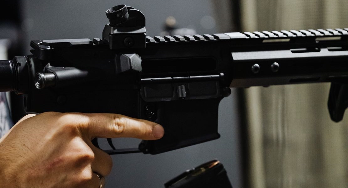 A person holding an AR-15