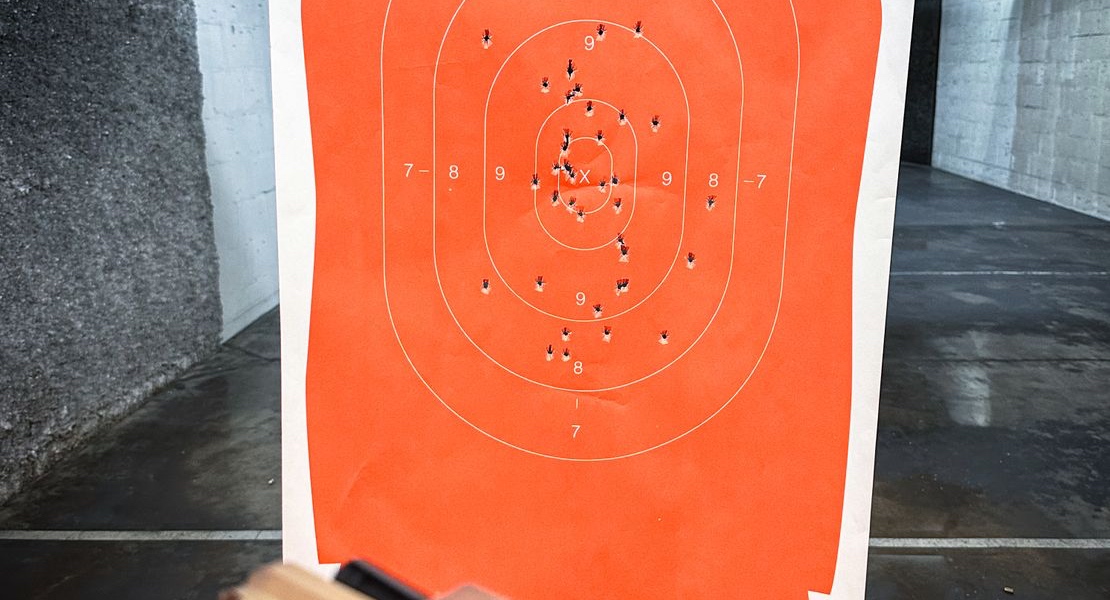 Paper target with bullet holes