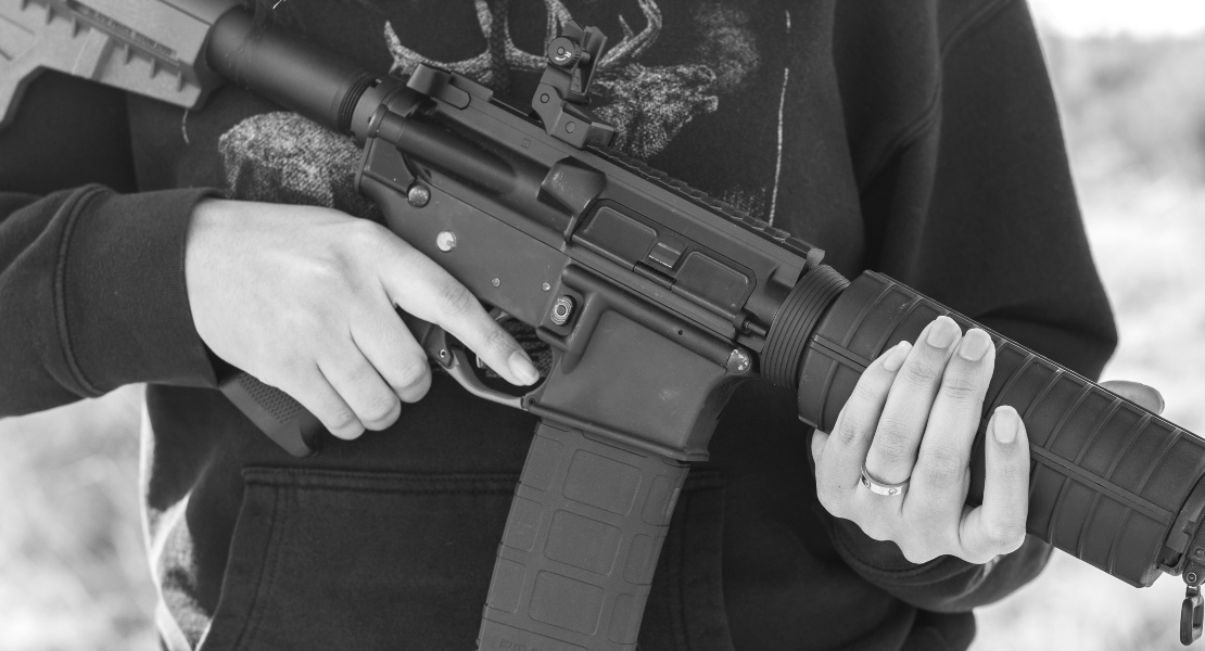 A man holding an AR15 rifle.