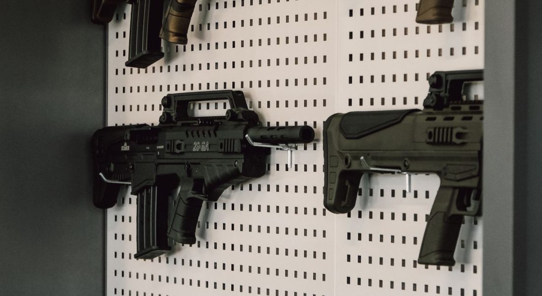 Collection of assault rifles mounted on a store display wall