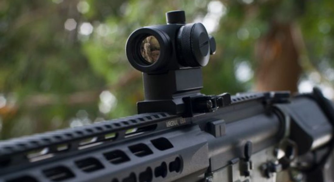 a detailed close-up of a tactical rifle with focus on the scope
